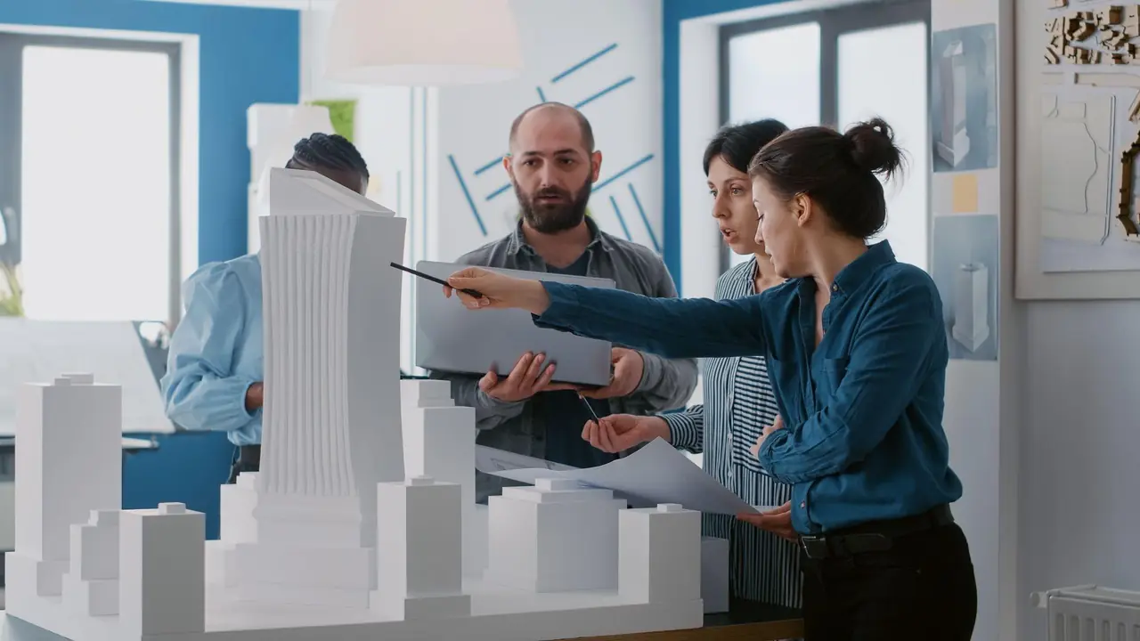 Construction team reviewing commercial building models and blueprints